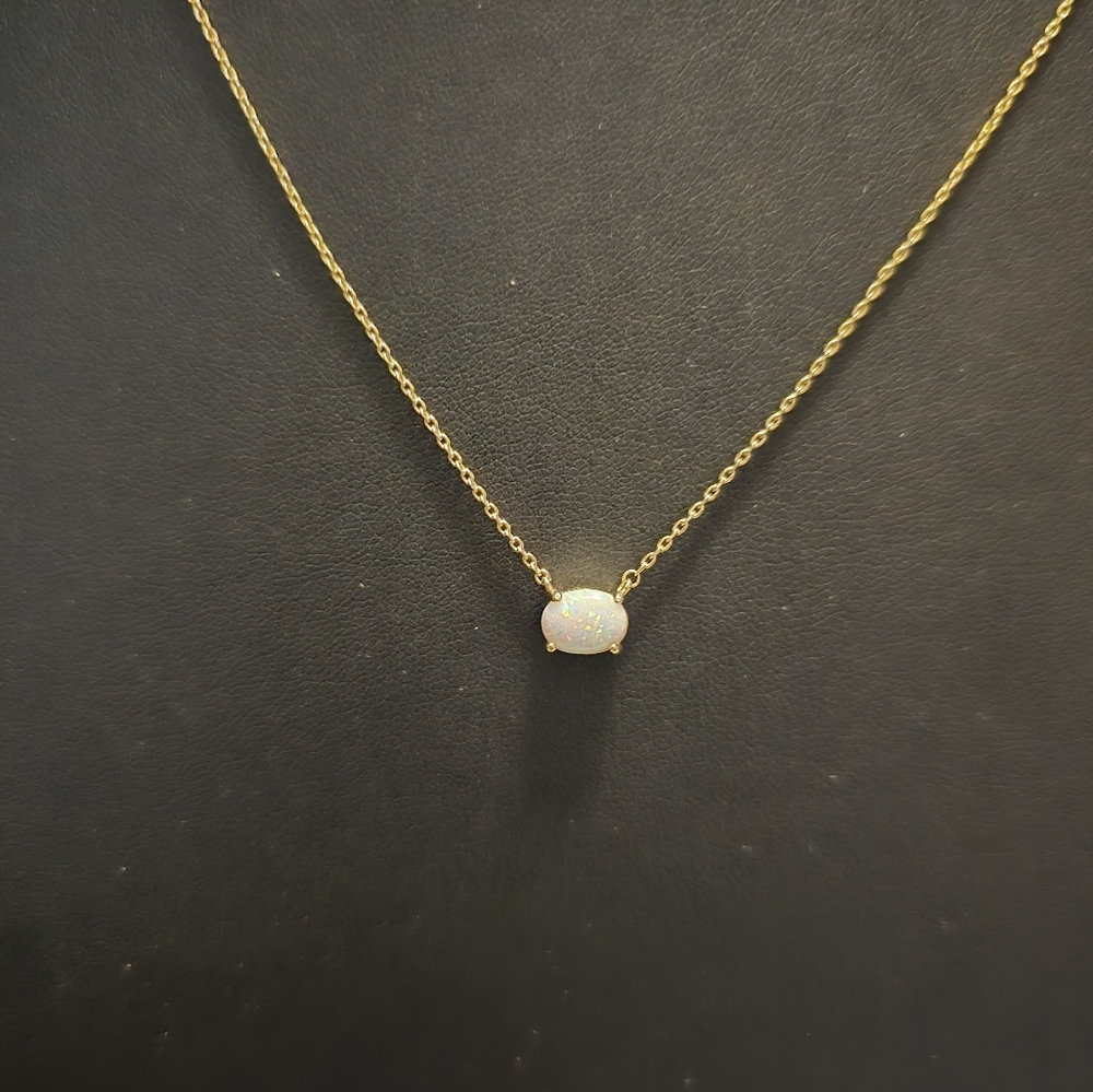 Opal oval stone with gold tone necklace, sixteen to eighteen length.